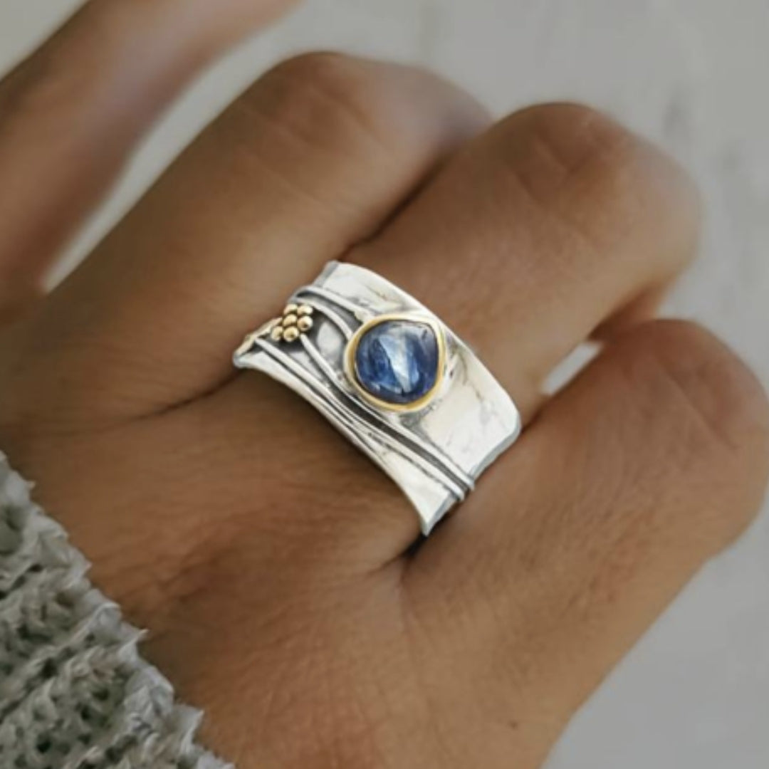 Vintage silver ring with oval blue crystal, gold bezel, textured bands with bead details