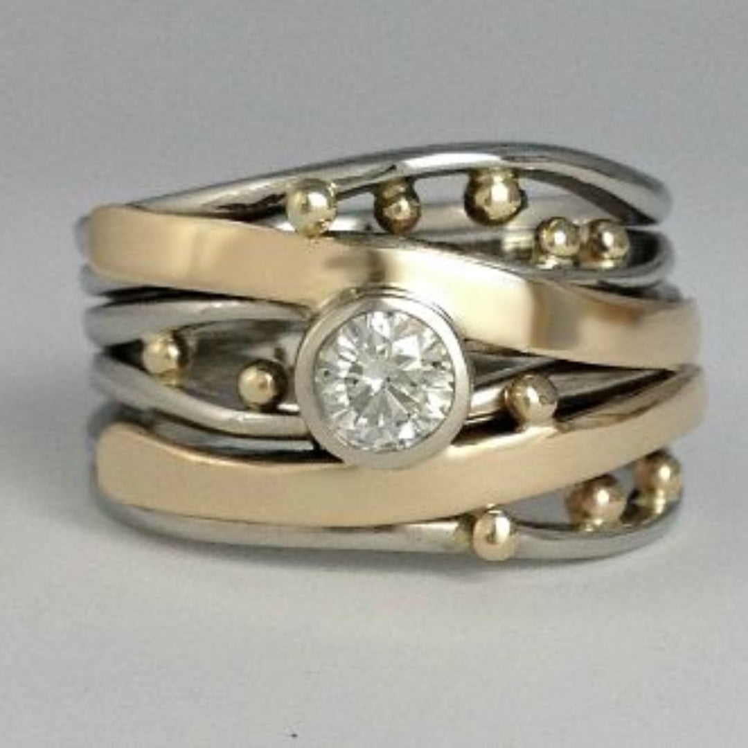 Two-tone vintage-style ring with round clear center stone and gold stud accents