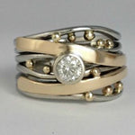 Two-tone vintage-style ring with round clear center stone and gold stud accents