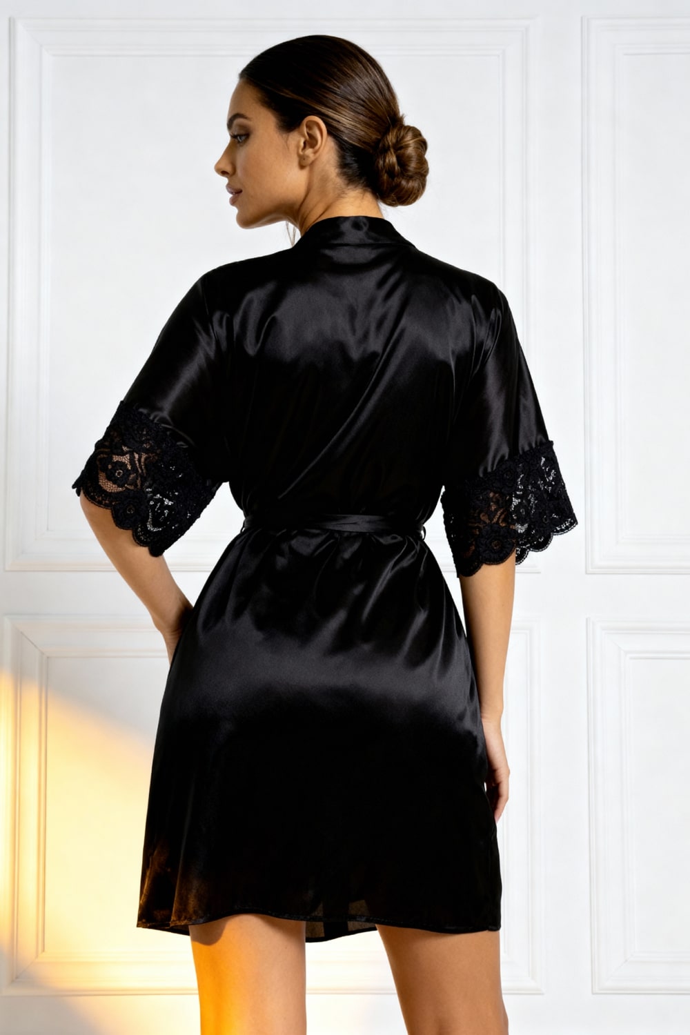 Black satin nightshirt robe from back view with lace-trim sleeves and waist tie