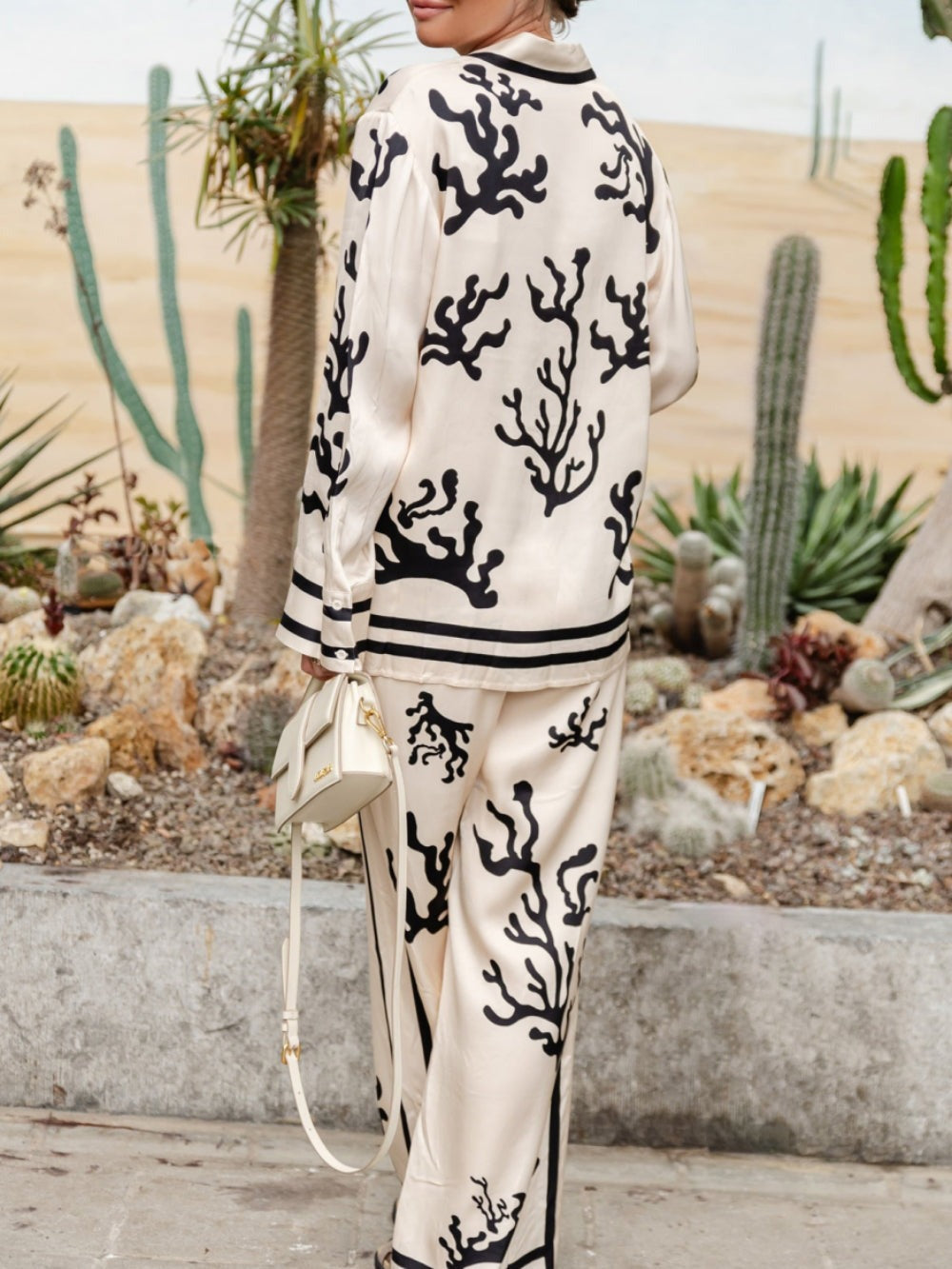 Silk pajama set in cream with black coral print, collared button shirt and wide-leg trousers