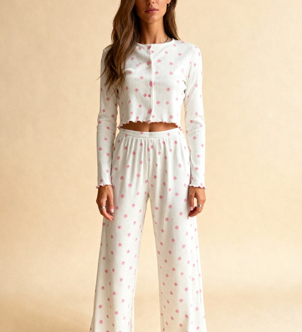 White capri pajama set with long sleeves, pink floral dots, elastic waist and wide legs.