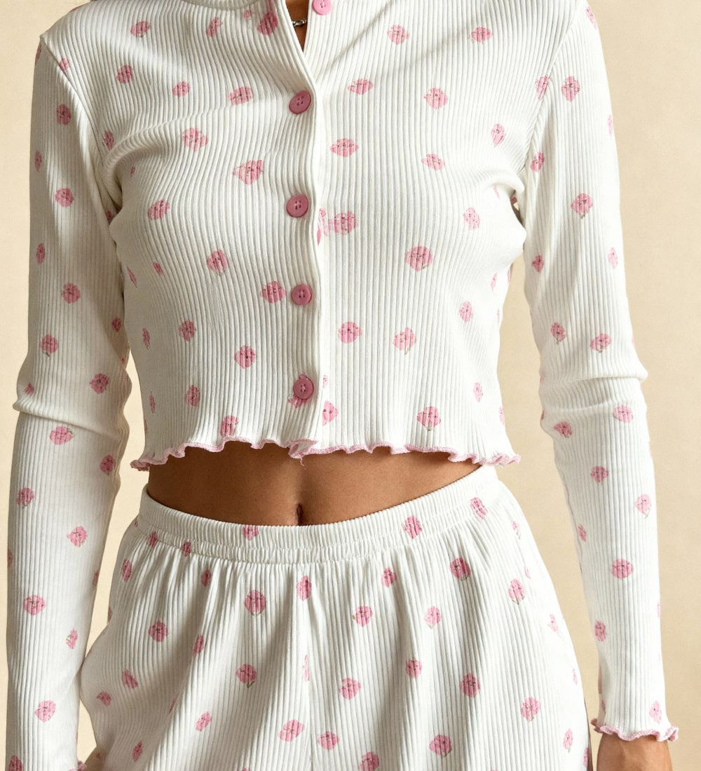 White long-sleeve pajama crop top with pink button placket and scattered pink flower print.