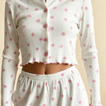White long-sleeve pajama crop top with pink button placket and scattered pink flower print.