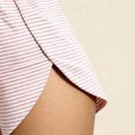 Pink striped shorts with elastic waistband and gathered hem, close-up