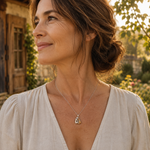 Hugging cat pendant necklace on woman, delicate chain with small gold-tone cat charm