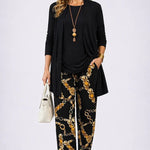 3-piece outfit set in black: long open jacket, top, and gold chain print pants