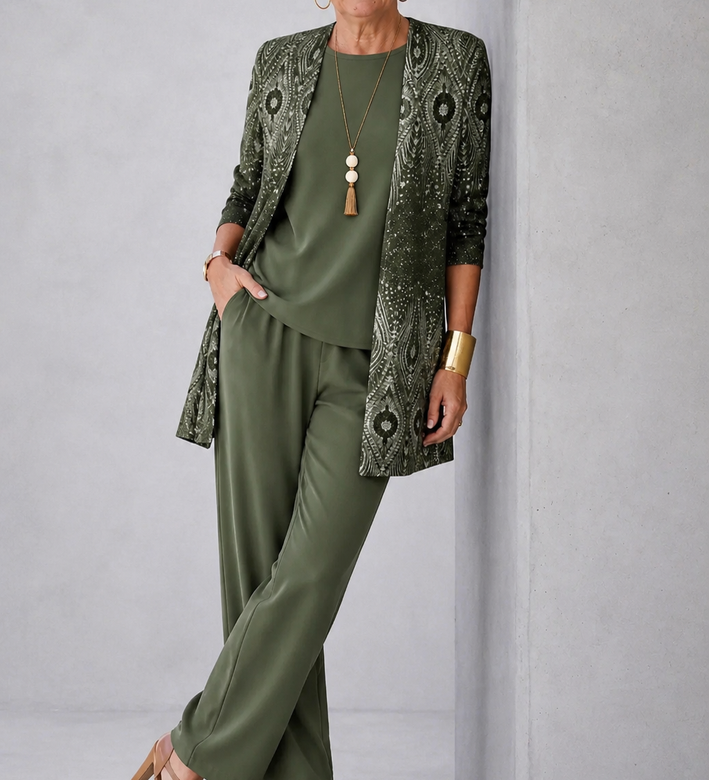 Three-piece dark green outfit: patterned tunic top, matching pants, elbow-length jacket