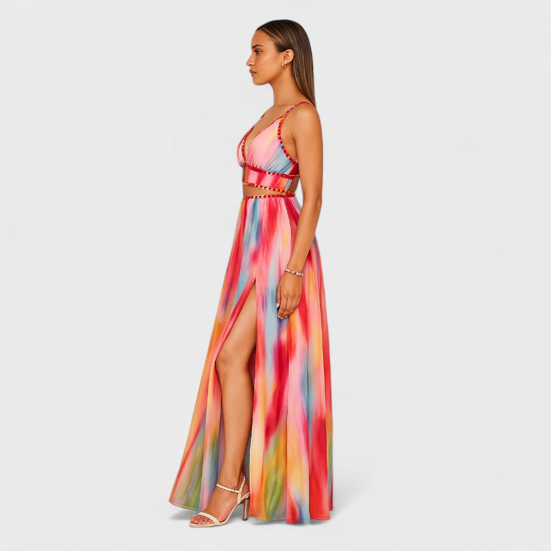Sleeveless long printed maxi dress with multicolor abstract print; high front slit, side view.