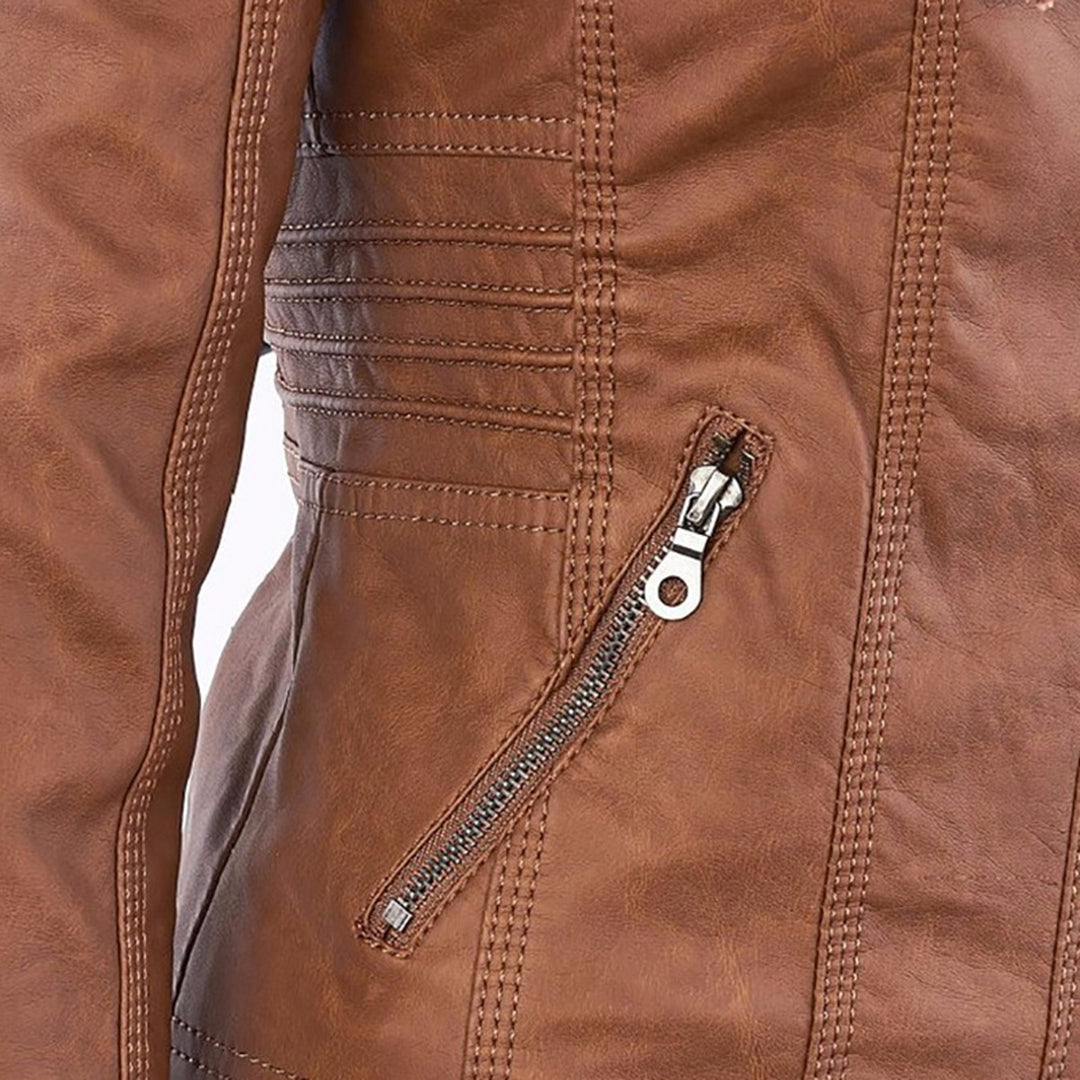 Close-up of brown faux-leather jacket zipper pull with side seam stitching