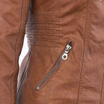 Close-up of brown faux-leather jacket zipper pull with side seam stitching