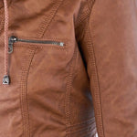 Close-up of brown faux-leather jacket: zip pocket and stitched panel seams