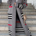 Long gray cardigan with black and white stripe bands and red stripe accent.