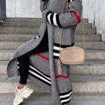 Long gray cardigan with black and white striped bands and red line detail.