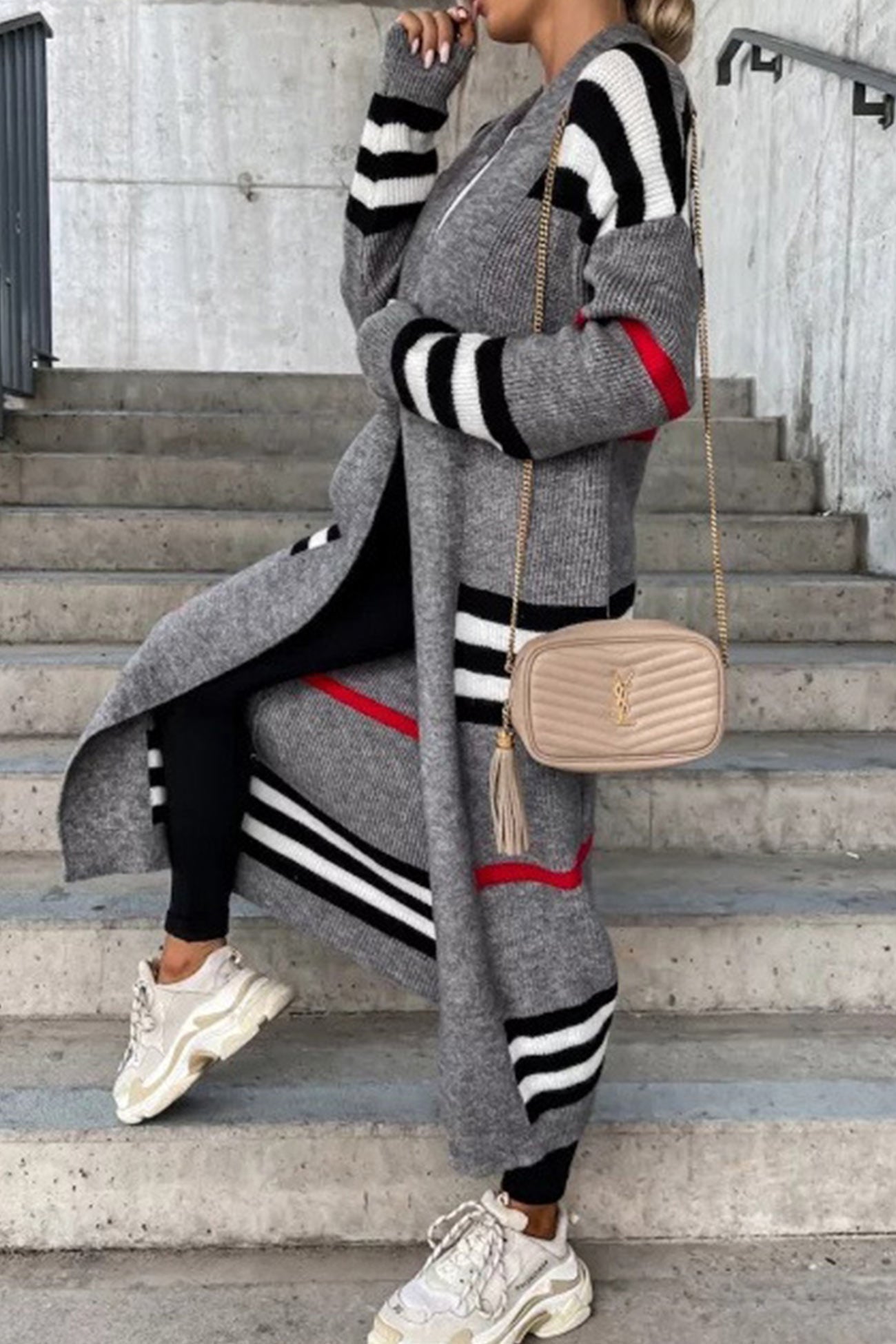 Long gray cardigan with black and white striped bands and red line detail.
