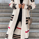 Long cream cardigan with bold black stripes, red accents, and open front.