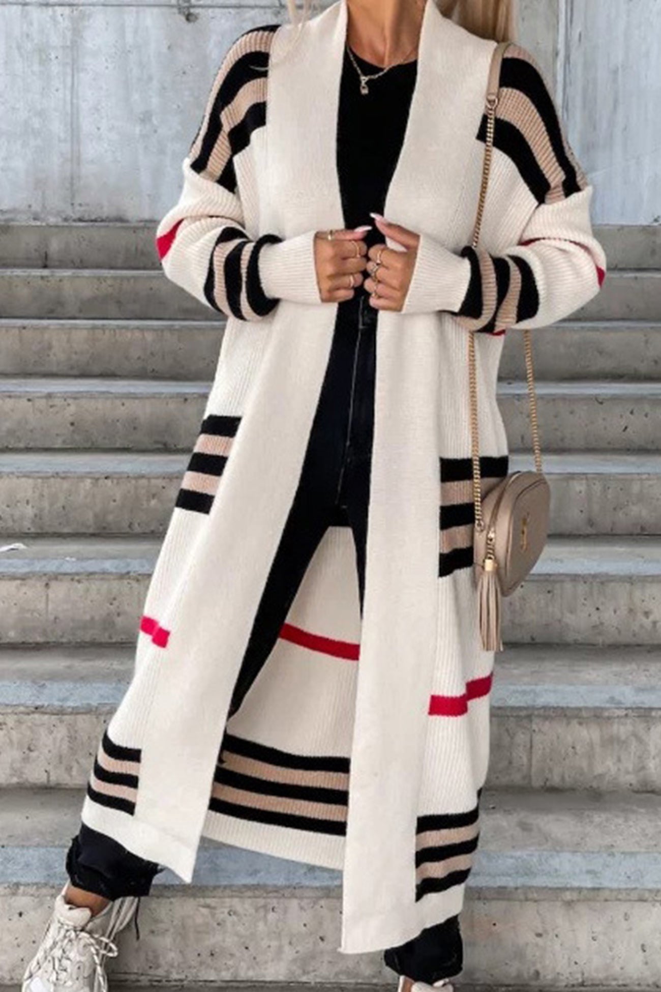 Long cream cardigan with bold black stripes, red accents, and open front.