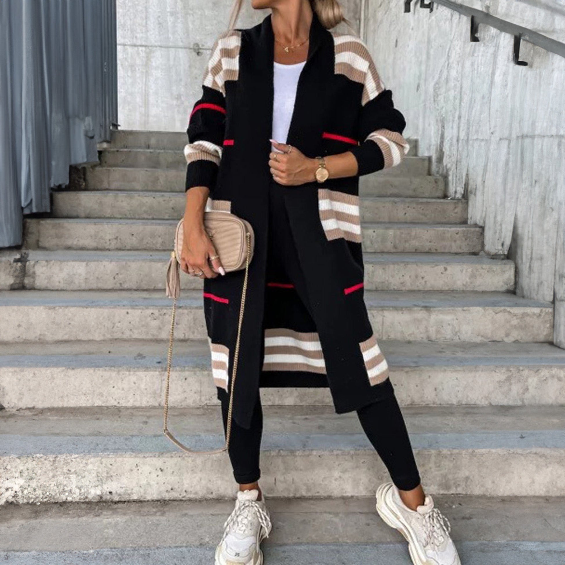 Long cardigan with black base, beige striped sleeves, and red stripe accents.