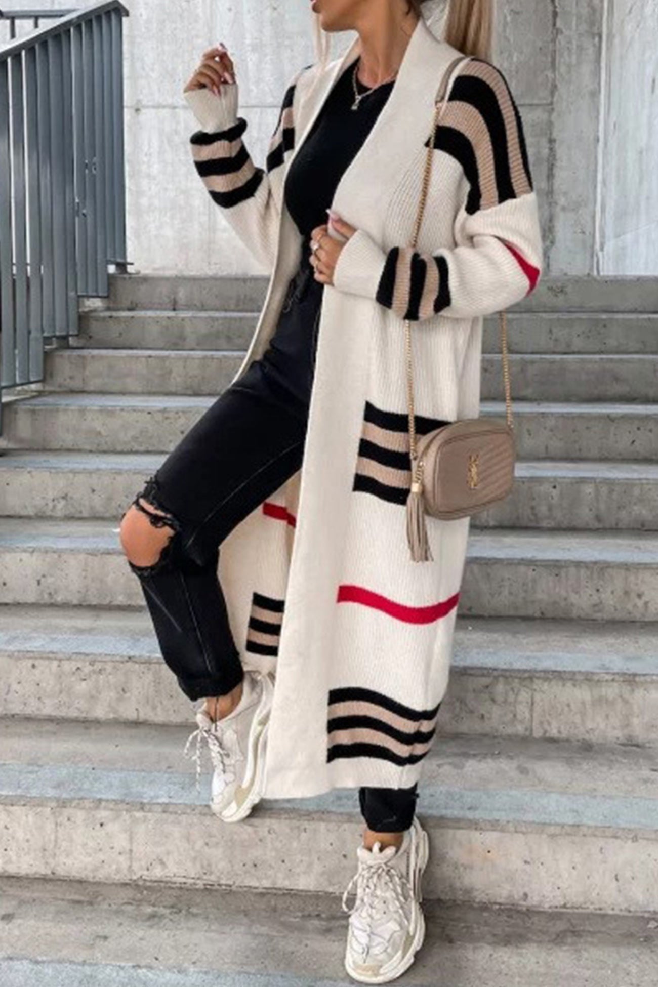 Long cream cardigan with black-and-white stripe bands and red accent stripe.