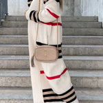 Long knit cardigan in cream with black stripe bands and red accents
