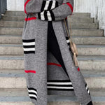 Long gray cardigan with black and white striped pattern and red stripe details.