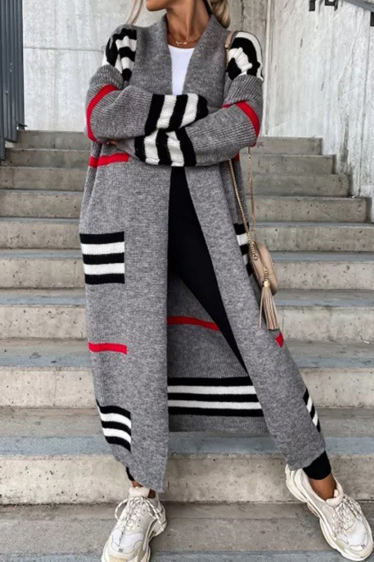 Long gray cardigan with black and white striped pattern and red stripe details.