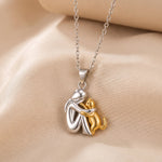 Hugging cat pendant necklace, silver-tone charm with gold-tone cat outline and chain