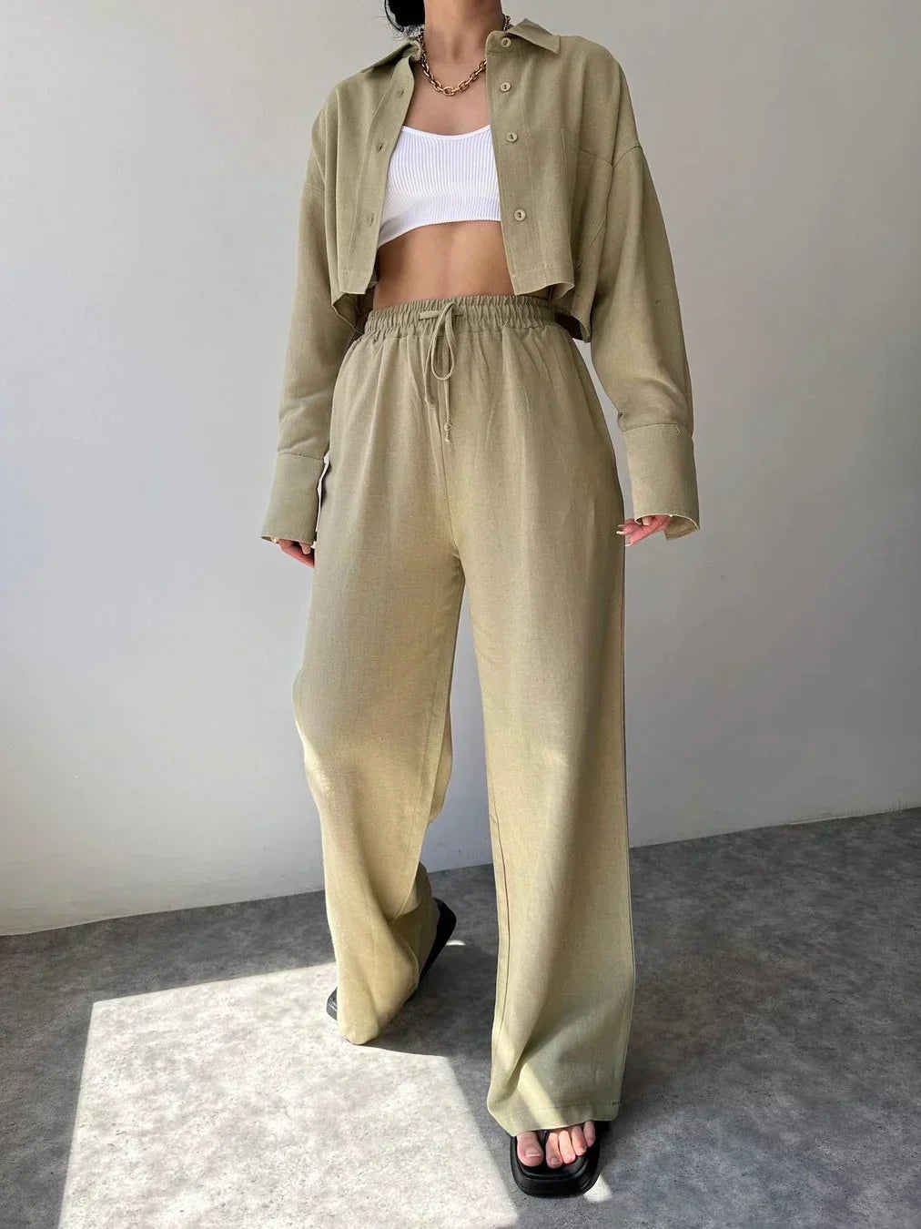 Olive two-piece set with collared button-up top and loose drawstring waist trousers