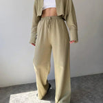 Olive two-piece set with collared button-up top and loose drawstring waist trousers