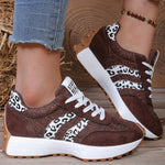 Dark brown lace-up sneakers with leopard-print panel and white stripes, thick sole