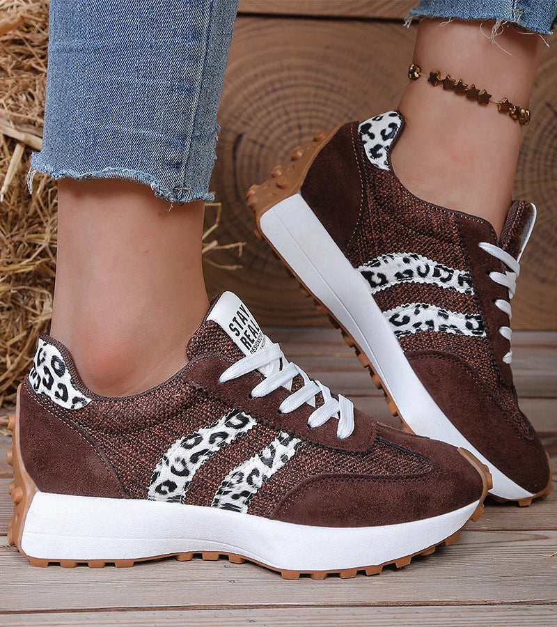 Dark brown lace-up sneakers with leopard-print panel and white stripes, thick sole