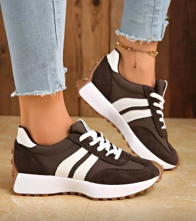 Brown and white lace-up sport sneakers with white stripe detail and low-profile sole