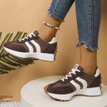 Brown and white lace-up sport sneakers with striped side panels, thick tread sole