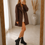 Brown comfort coat with notched lapels, double-breasted button closure, long sleeves