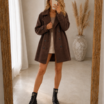 Brown comfort coat with double-breasted button front, notched lapels, above-knee length