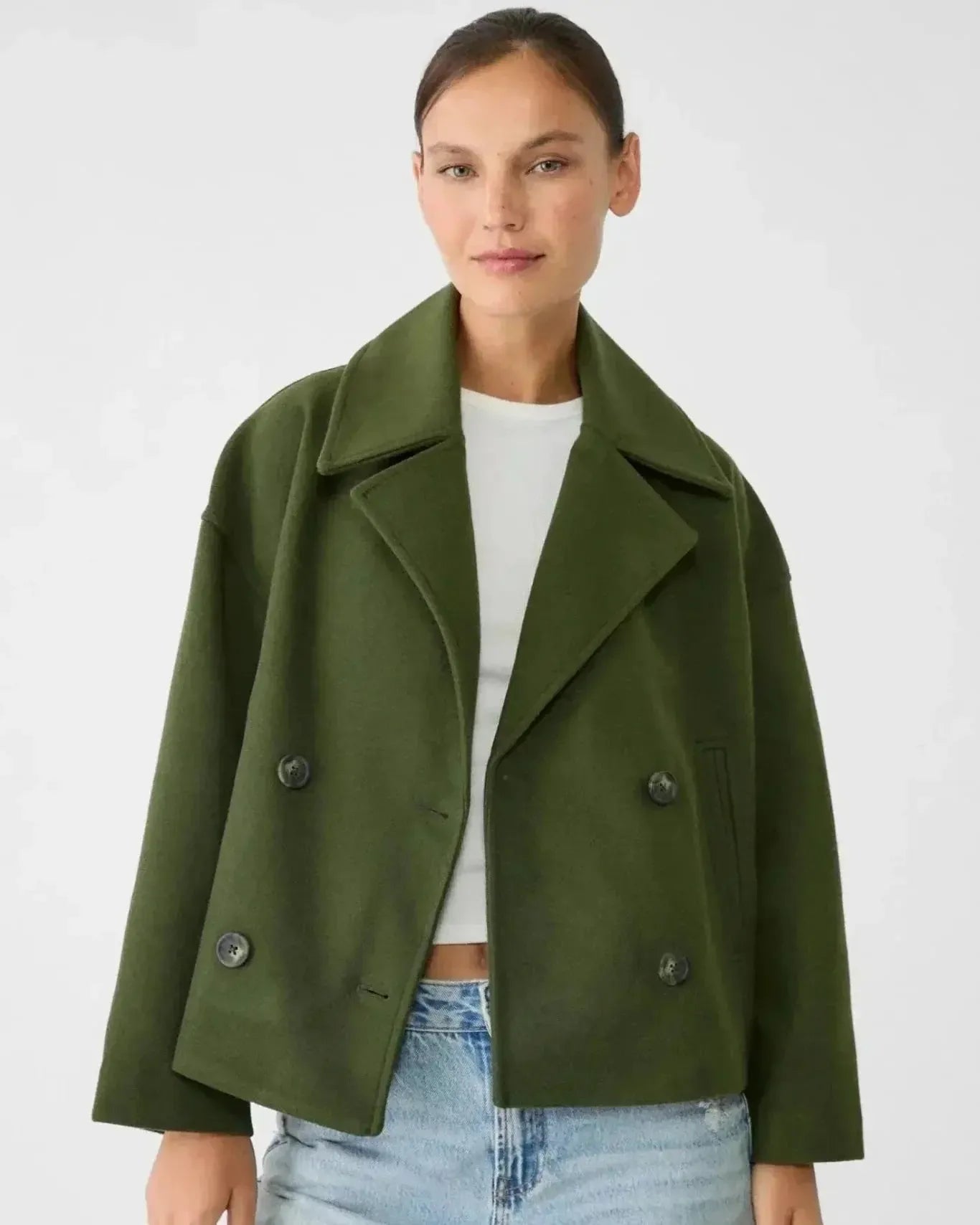 Green double-breasted coat with notch lapels and buttoned flap pockets.