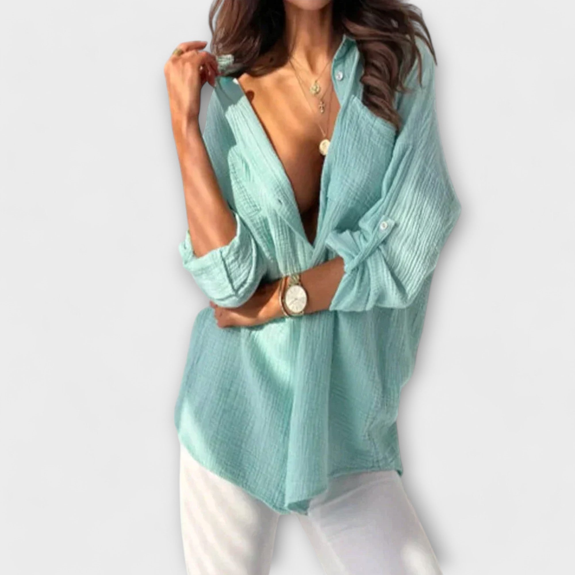 Teal women’s button-front blouse with long sleeves and collar.