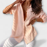 Light peach women’s button-front blouse with long sleeves and point collar.