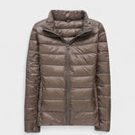 Taupe/brown puffer jacket with full front zipper and high stand collar.