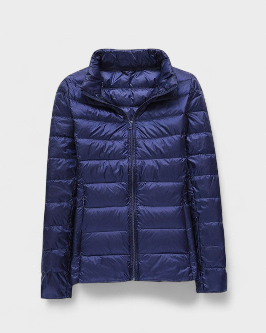 Navy blue puffer jacket with full front zipper and high stand collar, quilted panels.