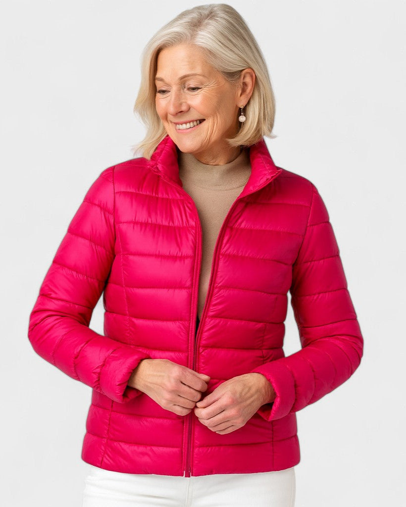 Bright pink puffer jacket with full zipper, stand collar, and quilted puffy panels.
