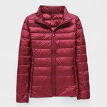 Burgundy red puffer jacket with full front zipper and high stand collar.