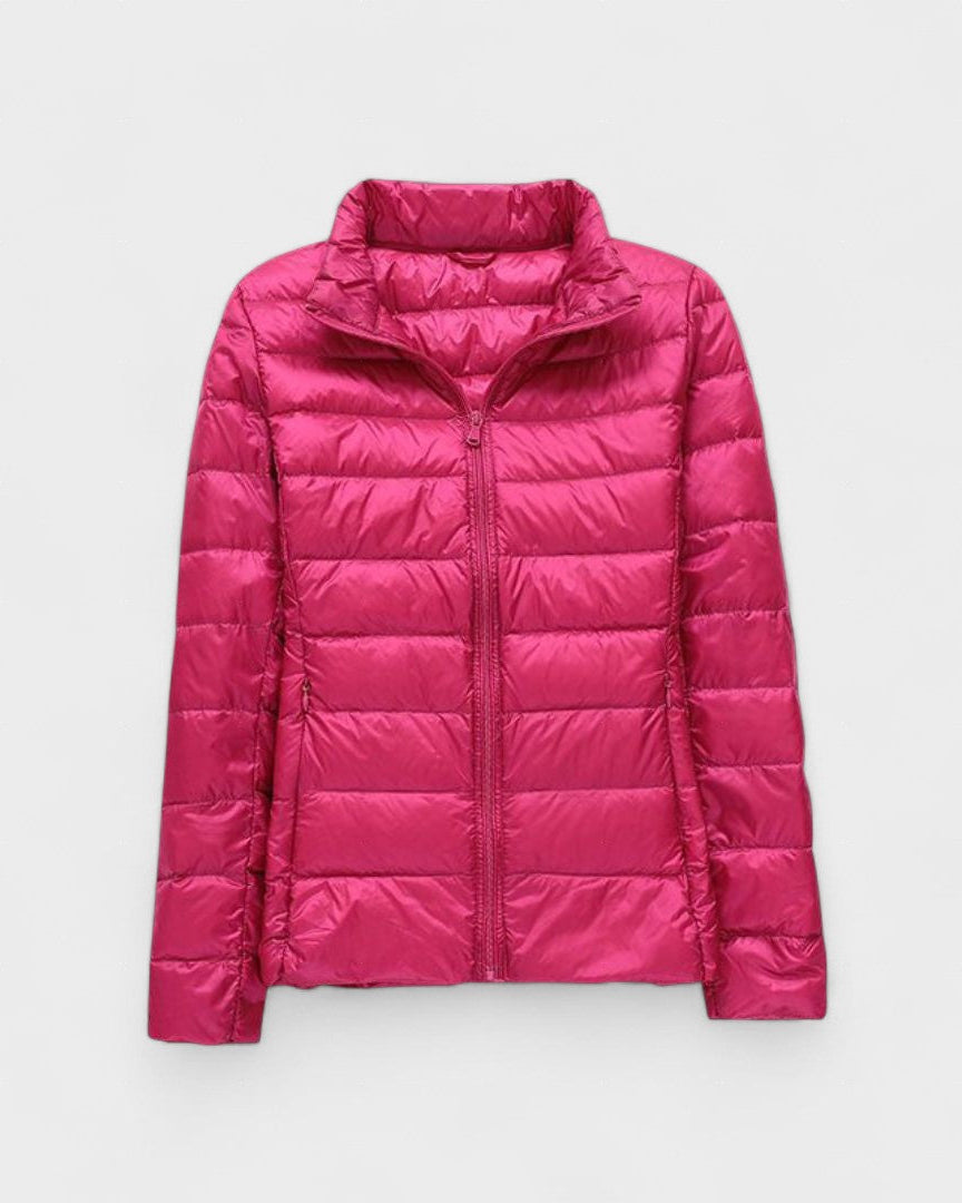 Fuchsia pink puffer jacket with full front zipper and high stand collar.