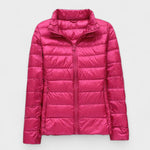 Fuchsia pink puffer jacket with full front zipper and high stand collar.