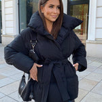 Black oversized puffer jacket with hood and tie belt, snap-button front
