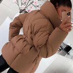 Tan-brown oversized puffer jacket with hood and tie belt, button front