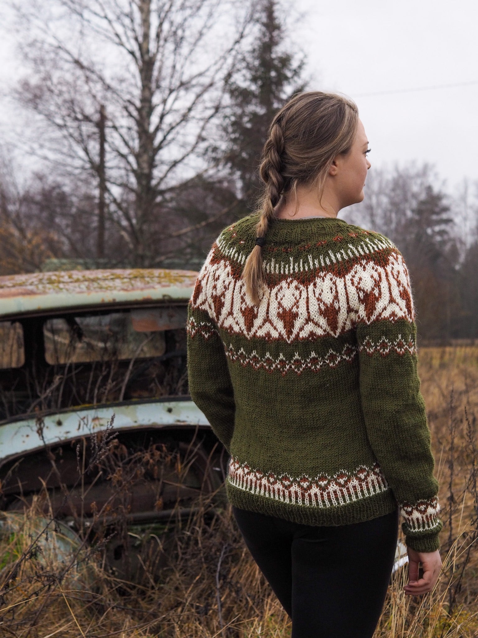 Back view of olive green Fair Isle sweater with white and red yoke and cuffs