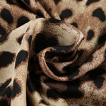 Leopard-print fabric close-up with black and tan spots