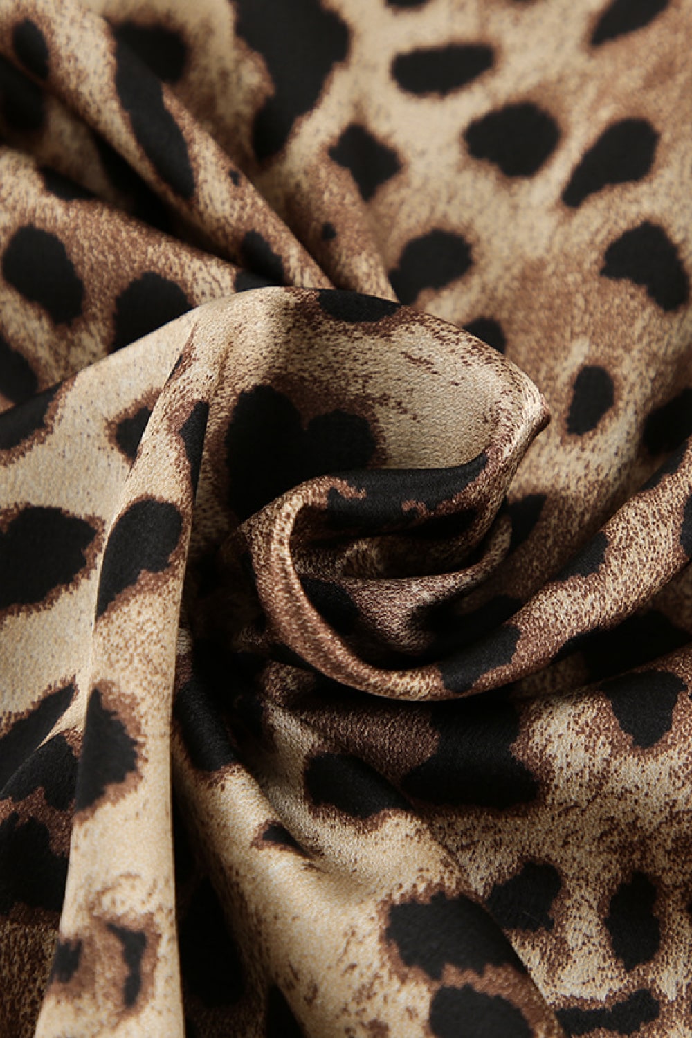 Leopard-print fabric close-up with black and tan spots