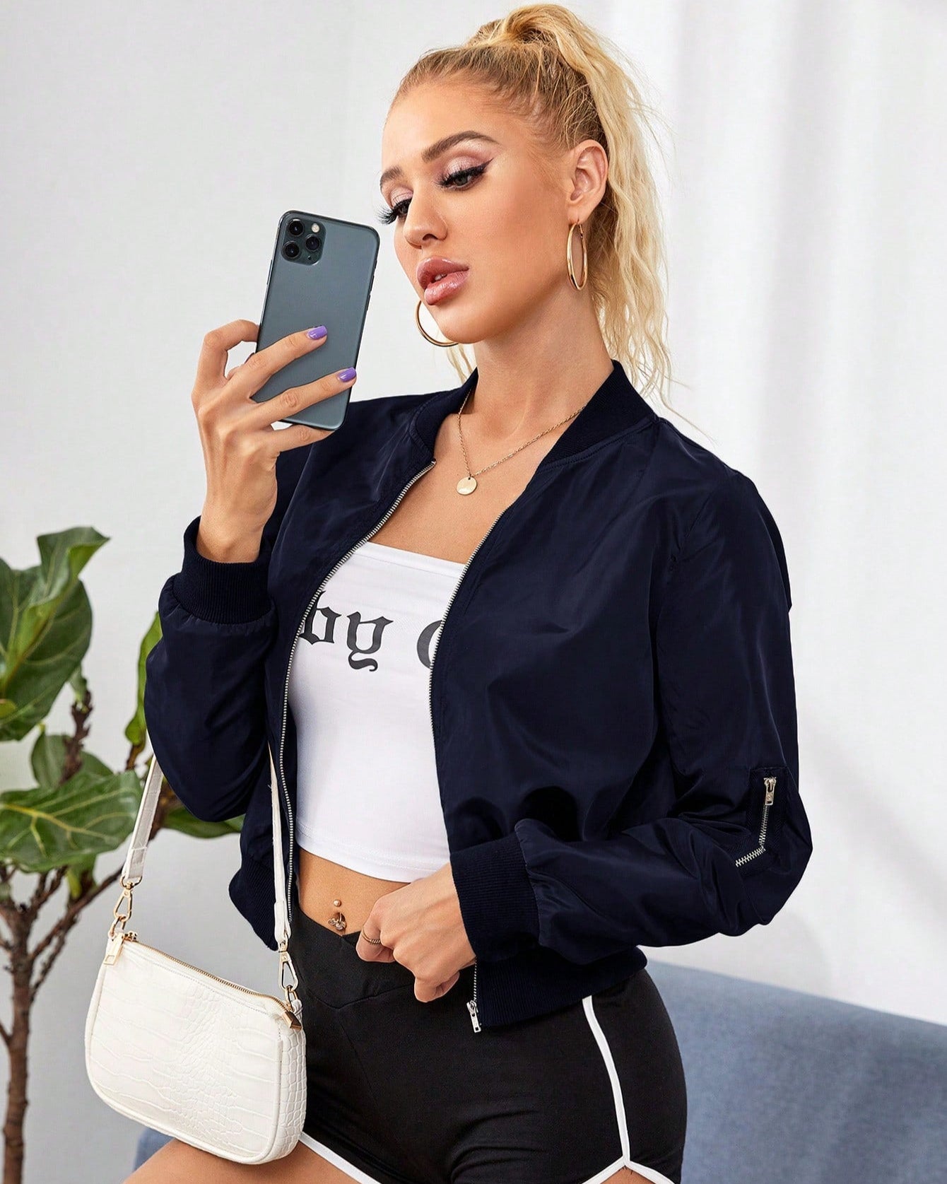 Navy short bomber jacket with front zipper and ribbed collar and cuffs